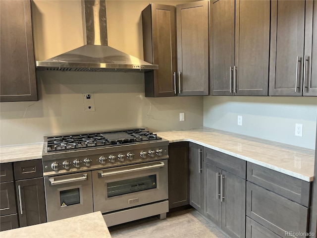 485 Cardiff Cir, Colorado Springs, CO 80906 - kitchen featuring double oven range, wall chimney range hood, light stone countertops, and dark brown cabinets