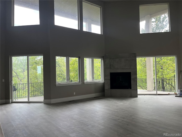 485 Cardiff Cir, Colorado Springs, CO 80906 - unfurnished living room featuring a high ceiling, baseboards, and healthy amount of natural light