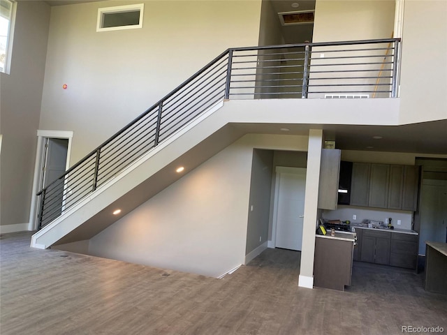 485 Cardiff Cir, Colorado Springs, CO 80906 - stairs featuring a high ceiling, wood finished floors, and baseboards