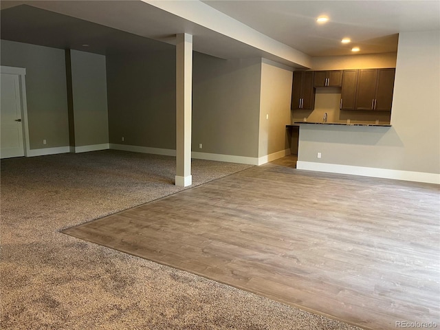 485 Cardiff Cir, Colorado Springs, CO 80906 - kitchen featuring baseboards, recessed lighting, dark brown cabinetry, open floor plan, and light wood-style flooring