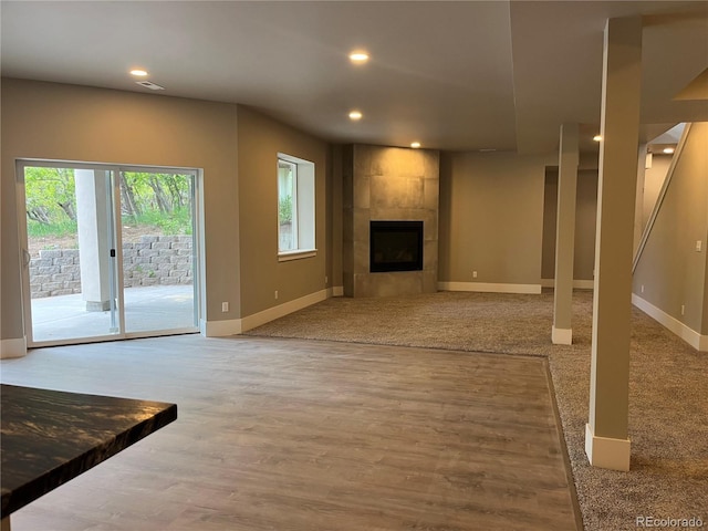 485 Cardiff Cir, Colorado Springs, CO 80906 - unfurnished living room featuring baseboards, a tile fireplace, recessed lighting, and wood finished floors