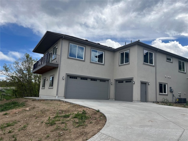 485 Cardiff Cir, Colorado Springs, CO 80906 - view of front facade with a garage, stucco siding, driveway, central air condition unit, and a balcony