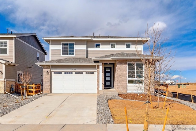 view of front of home with a garage, brick siding, driveway, and fence