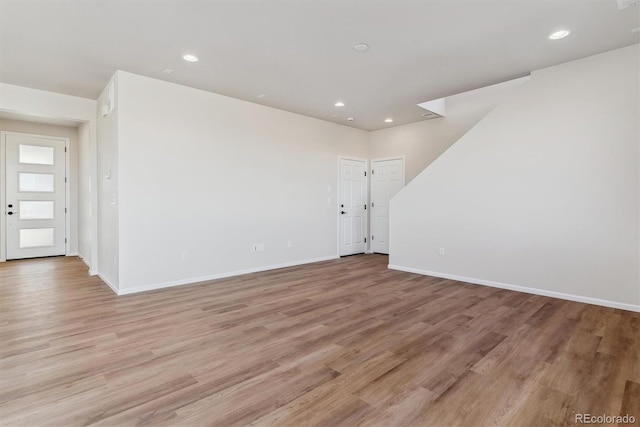 empty room featuring light wood-style flooring and baseboards