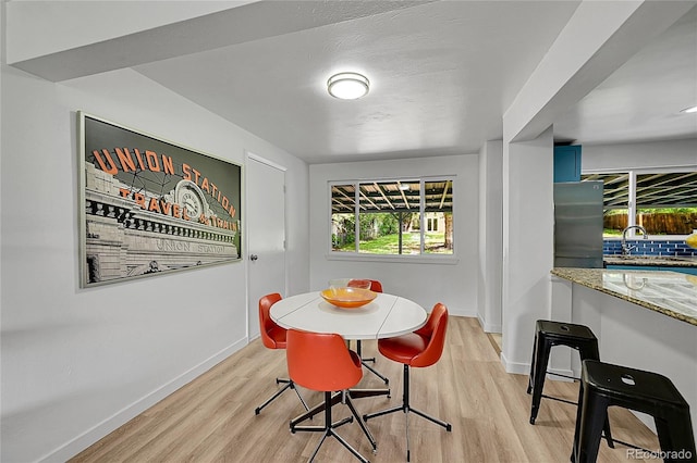 1552 W Caley Ave, Littleton, CO 80120 - dining space with baseboards and light wood-style floors
