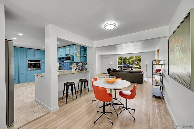 1552 W Caley Ave, Littleton, CO 80120 - dining room featuring baseboards and light wood-type flooring