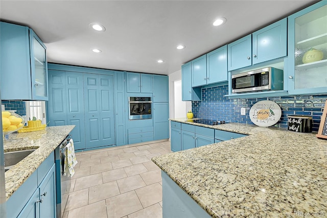 1552 W Caley Ave, Littleton, CO 80120 - kitchen with stainless steel appliances, blue cabinetry, backsplash, light stone counters, and recessed lighting