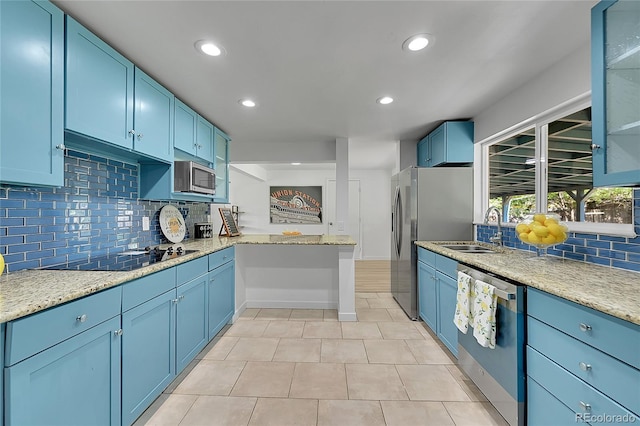 1552 W Caley Ave, Littleton, CO 80120 - kitchen featuring stainless steel appliances, blue cabinets, a peninsula, decorative backsplash, and recessed lighting