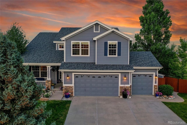 4069 Copper Ct, Castle Rock, CO 80104 - view of front facade featuring roof with shingles, driveway, stone siding, and an attached garage
