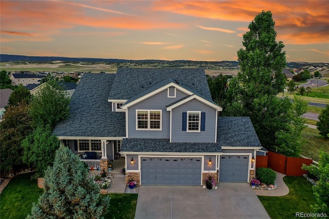 4069 Copper Ct, Castle Rock, CO 80104 - view of front of home with concrete driveway, roof with shingles, stone siding, and covered porch