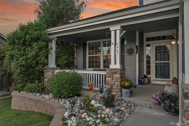 4069 Copper Ct, Castle Rock, CO 80104 - exterior entry at dusk featuring covered porch and stone siding