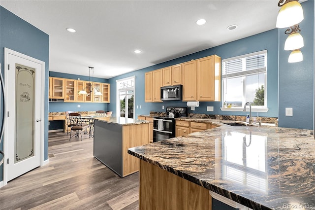 4069 Copper Ct, Castle Rock, CO 80104 - kitchen with range with electric cooktop, light brown cabinets, glass insert cabinets, recessed lighting, and a kitchen island