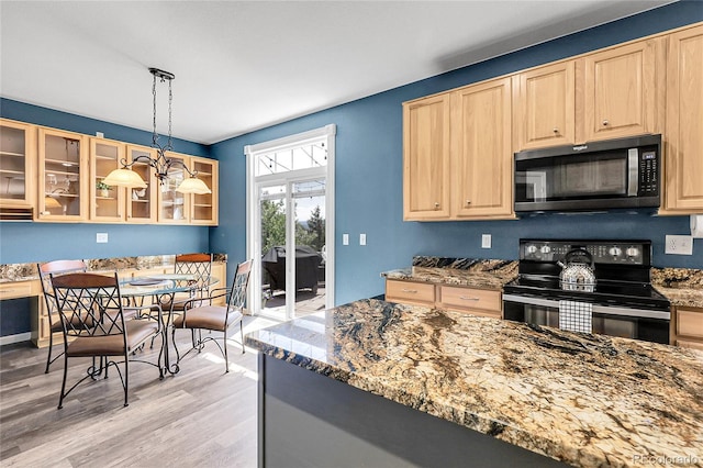 4069 Copper Ct, Castle Rock, CO 80104 - kitchen with black electric range, light brown cabinets, light wood-type flooring, and stone countertops