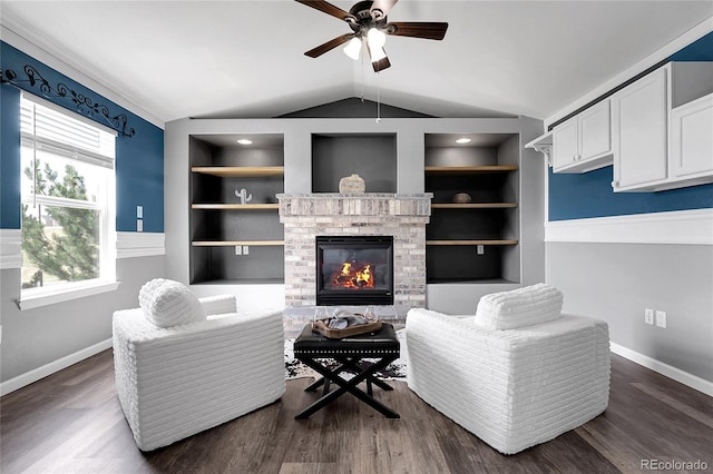 4069 Copper Ct, Castle Rock, CO 80104 - living area with a ceiling fan, built in shelves, lofted ceiling, a brick fireplace, and dark wood-type flooring