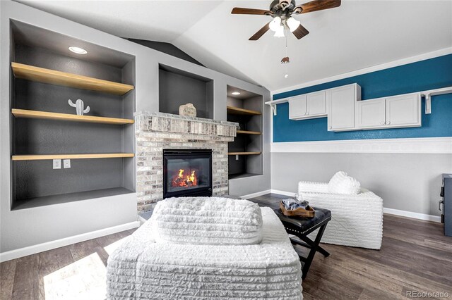 4069 Copper Ct, Castle Rock, CO 80104 - living room with built in features, a ceiling fan, vaulted ceiling, dark wood-style flooring, and a fireplace