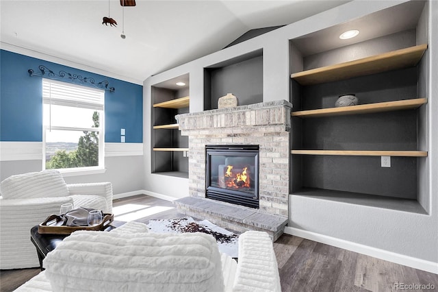 4069 Copper Ct, Castle Rock, CO 80104 - living room with lofted ceiling, a brick fireplace, built in features, and wood finished floors