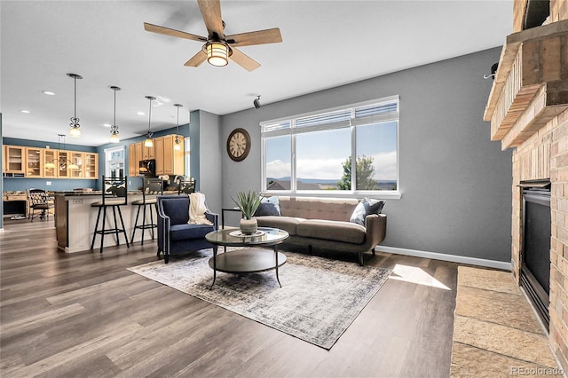 4069 Copper Ct, Castle Rock, CO 80104 - living area featuring a brick fireplace, wood finished floors, a ceiling fan, and recessed lighting