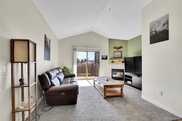 carpeted living room featuring baseboards, lofted ceiling, and a fireplace