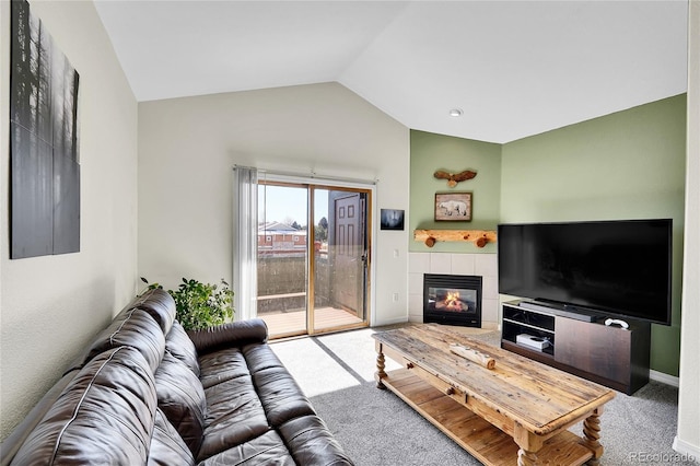 living room featuring carpet flooring, a fireplace, baseboards, and vaulted ceiling