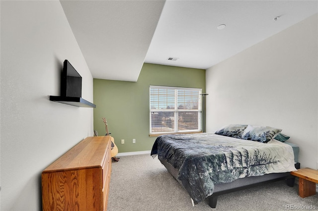 carpeted bedroom featuring visible vents and baseboards