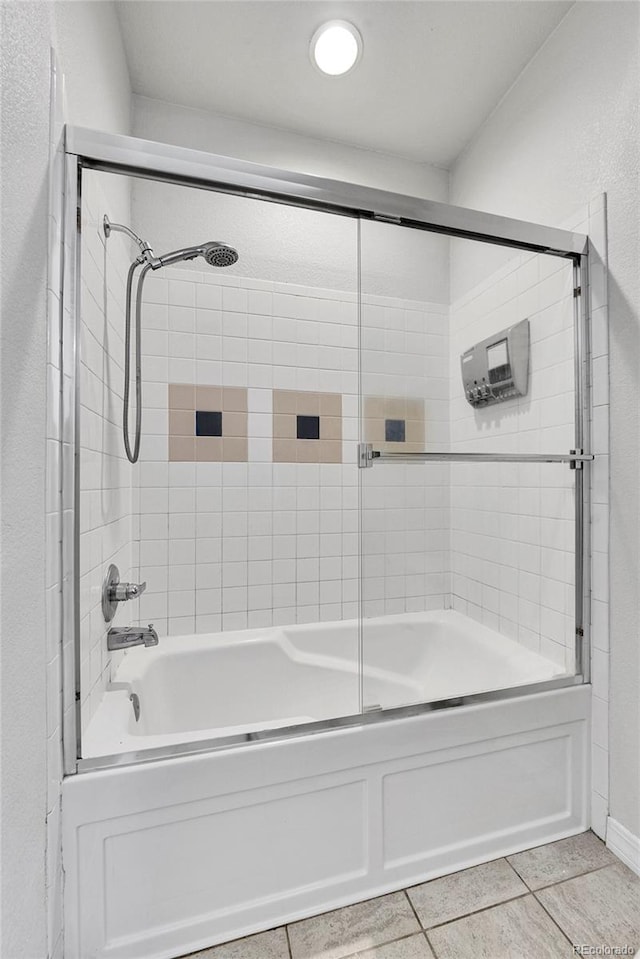 full bath featuring enclosed tub / shower combo and tile patterned flooring