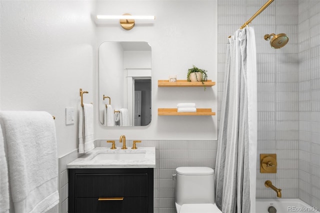 2995 Yates St, Denver, CO 80212 - full bath with wainscoting, vanity, shower / bath combo with shower curtain, and tile walls