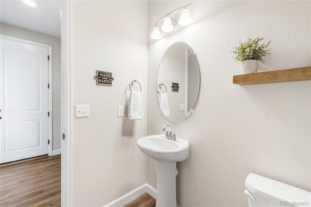 7678 S Old Hammer Way, Aurora, CO 80016 - half bath with wood finished floors, toilet, and baseboards