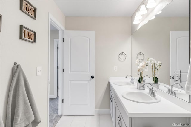 7678 S Old Hammer Way, Aurora, CO 80016 - bathroom featuring tile patterned floors, double vanity, and baseboards