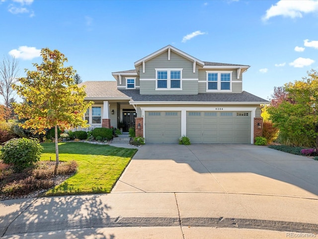 view of front of property with a porch, a garage, and a front lawn