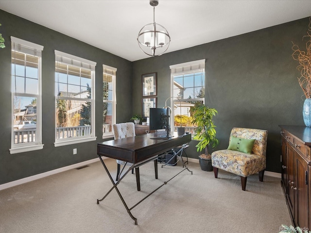 carpeted office featuring an inviting chandelier and plenty of natural light