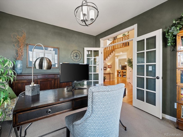 office space featuring light carpet, french doors, and a chandelier