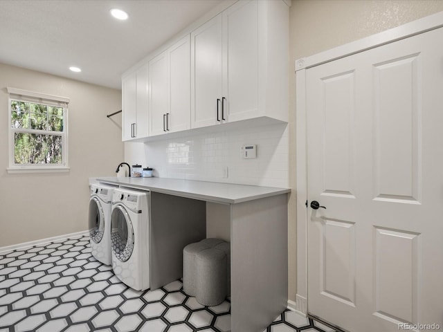 washroom with cabinets and separate washer and dryer