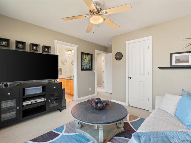 carpeted living room featuring ceiling fan