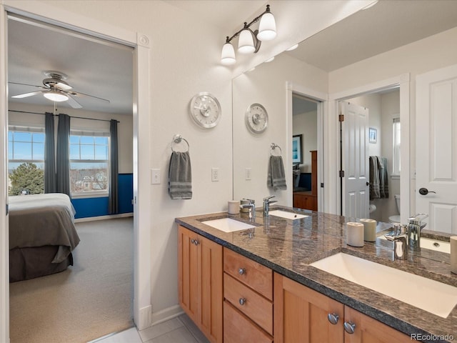 bathroom featuring ceiling fan, toilet, and vanity