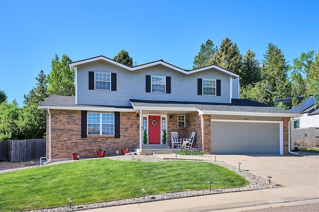 7822 W Ottawa Pl, Littleton, CO 80128 - traditional-style house with brick siding, concrete driveway, and roof with shingles