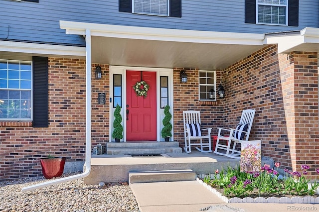 7822 W Ottawa Pl, Littleton, CO 80128 - property entrance featuring brick siding and covered porch