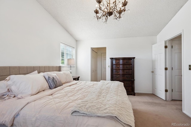 7822 W Ottawa Pl, Littleton, CO 80128 - bedroom featuring light carpet, a textured ceiling, a chandelier, vaulted ceiling, and baseboards
