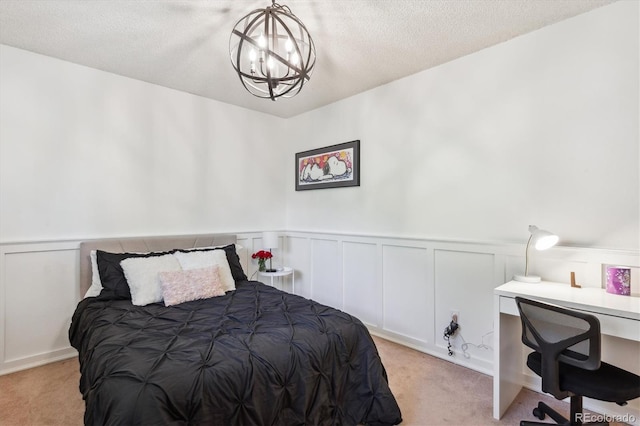 7822 W Ottawa Pl, Littleton, CO 80128 - bedroom with light colored carpet, a chandelier, a desk, a wainscoted wall, and a decorative wall