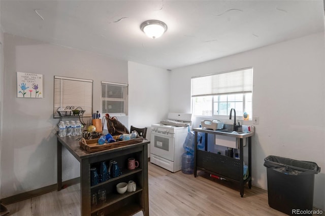 358 S Osceola St, Denver, CO 80219 - kitchen with white range with gas stovetop and light wood finished floors