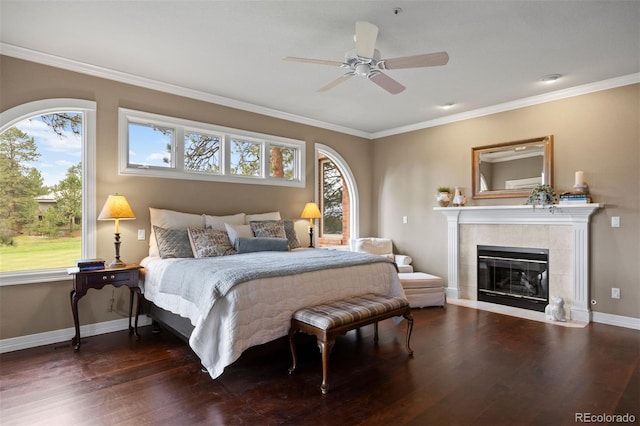 120 Silver Leaf Way, Castle Rock, CO 80108 - bedroom with ornamental molding, wood finished floors, baseboards, a tiled fireplace, and ceiling fan