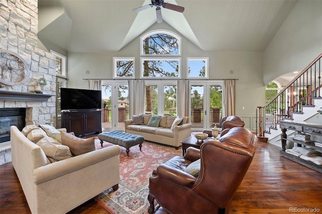 120 Silver Leaf Way, Castle Rock, CO 80108 - living area featuring high vaulted ceiling, stairs, a fireplace, ceiling fan, and wainscoting