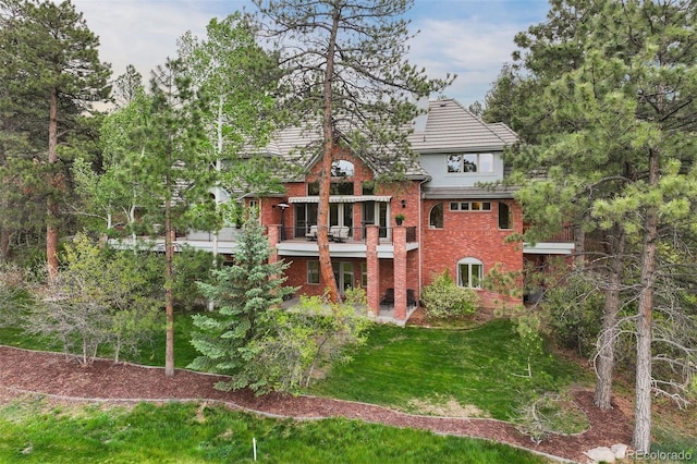 120 Silver Leaf Way, Castle Rock, CO 80108 - rear view of property with brick siding and a lawn