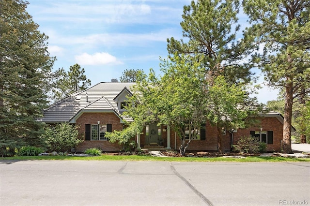 120 Silver Leaf Way, Castle Rock, CO 80108 - obstructed view of property with brick siding, a chimney, and a tiled roof