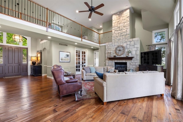 120 Silver Leaf Way, Castle Rock, CO 80108 - living area with high vaulted ceiling, a ceiling fan, hardwood / wood-style floors, a fireplace, and arched walkways