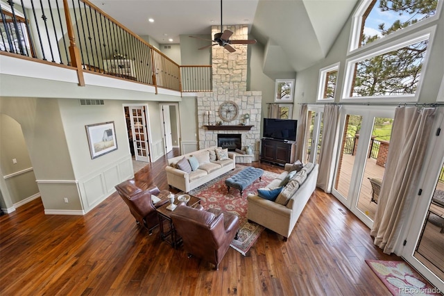 120 Silver Leaf Way, Castle Rock, CO 80108 - living room featuring high vaulted ceiling, a fireplace, a ceiling fan, hardwood / wood-style floors, and baseboards