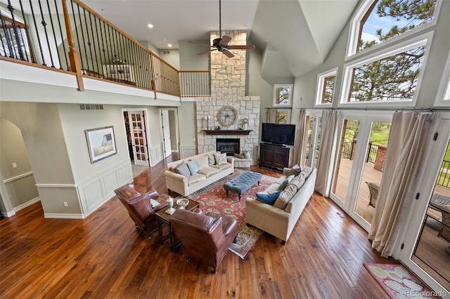 120 Silver Leaf Way, Castle Rock, CO 80108 - living area featuring high vaulted ceiling, a ceiling fan, hardwood / wood-style floors, and a stone fireplace