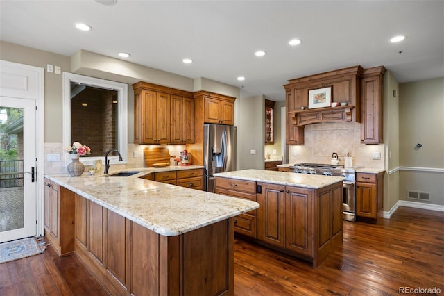120 Silver Leaf Way, Castle Rock, CO 80108 - kitchen featuring a sink, stainless steel appliances, brown cabinetry, dark wood-type flooring, and recessed lighting