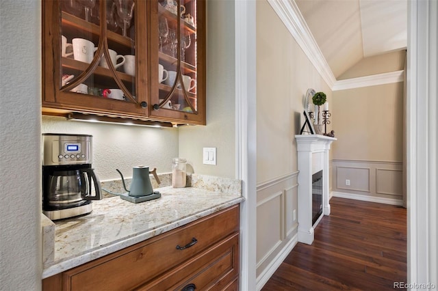 120 Silver Leaf Way, Castle Rock, CO 80108 - bar area with dark wood-style flooring, vaulted ceiling, crown molding, a wainscoted wall, and a decorative wall