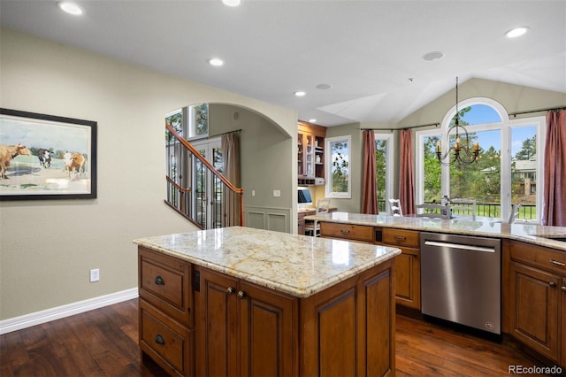 120 Silver Leaf Way, Castle Rock, CO 80108 - kitchen featuring stainless steel dishwasher, brown cabinets, a kitchen island, lofted ceiling, and light stone counters