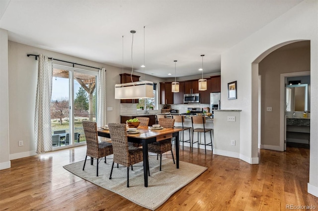 dining area featuring sink and light hardwood / wood-style flooring